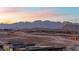 Breathtaking mountain view at sunset over new construction homes in the desert at 11015 Sanctuary Cove Ct, Las Vegas, NV 89135