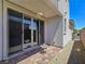Private back patio with brick pavers, sliding glass doors, and a low-maintenance gravel border at 11739 Emerald Lake Ave, Las Vegas, NV 89138