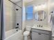 Modern bathroom with a tub-shower combo, gray vanity, and matte black fixtures at 11739 Emerald Lake Ave, Las Vegas, NV 89138