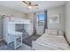 Bright bedroom features a bunk bed with desk and a separate bed with a ceiling fan at 11739 Emerald Lake Ave, Las Vegas, NV 89138
