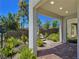 Welcoming covered patio featuring brick flooring, desert landscaping, and shade from the sun at 11739 Emerald Lake Ave, Las Vegas, NV 89138