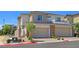 Two-story home featuring a two-car garage, modern exterior accents, and drought-resistant landscaping at 11739 Emerald Lake Ave, Las Vegas, NV 89138