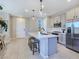 Bright kitchen features an island with seating, stainless steel appliances, and sleek countertops at 11739 Emerald Lake Ave, Las Vegas, NV 89138