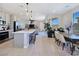 Open-concept living space featuring a kitchen island, stainless appliances, and an adjacent dining area at 11739 Emerald Lake Ave, Las Vegas, NV 89138