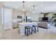 Contemporary kitchen featuring an island with seating, stainless steel appliances, and open floor plan at 11739 Emerald Lake Ave, Las Vegas, NV 89138