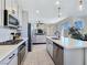 Well-lit kitchen boasting stainless steel appliances, island with seating, and sliding glass doors at 11739 Emerald Lake Ave, Las Vegas, NV 89138