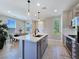Open concept kitchen with an island, modern lighting, and seamlessly flowing into the dining area at 11739 Emerald Lake Ave, Las Vegas, NV 89138