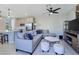 Open-concept living room with a large sectional sofa, stylish decor, and an adjacent modern kitchen at 11739 Emerald Lake Ave, Las Vegas, NV 89138