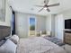 The main bedroom offers neutral decor, a ceiling fan, patio access, and comfortable furnishings at 11739 Emerald Lake Ave, Las Vegas, NV 89138