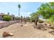 Wide backyard featuring desert landscaping with mature trees and shrubs at 120 W Highland Dr, Henderson, NV 89015