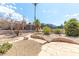 Desert landscaped backyard featuring stone accents, mature trees, and spacious patio area at 120 W Highland Dr, Henderson, NV 89015
