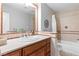 Bathroom featuring tiled walls, vanity with sink, and tub shower combo at 120 W Highland Dr, Henderson, NV 89015