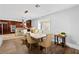 Bright dining room with wood floors, a large window, and seamless access to kitchen at 120 W Highland Dr, Henderson, NV 89015