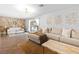 Open living room with wood floors, modern furniture, sliding glass doors, and accent wall at 120 W Highland Dr, Henderson, NV 89015