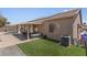 Fenced backyard featuring a covered patio, artificial grass, and pool access at 1310 Ripplestone Ave, North Las Vegas, NV 89081