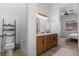 Elegant bathroom with double vanity, modern fixtures, and a view into the bedroom at 1310 Ripplestone Ave, North Las Vegas, NV 89081