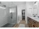 Modern bathroom with glass-enclosed shower, subway tile, and stylish vanity with dual sinks at 1310 Ripplestone Ave, North Las Vegas, NV 89081