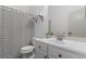 Bathroom featuring a shower with a striped curtain, toilet, sink, and mirror at 1310 Ripplestone Ave, North Las Vegas, NV 89081