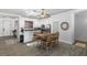 A combined dining and kitchen area featuring a skylight and a six seat wooden dining table at 1310 Ripplestone Ave, North Las Vegas, NV 89081
