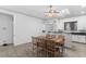 Bright dining room featuring a skylight, light colored walls, and a wooden dining table with seating for six at 1310 Ripplestone Ave, North Las Vegas, NV 89081