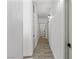 Bright hallway with wood-look flooring leading to various rooms and doorways inside this residential home at 1310 Ripplestone Ave, North Las Vegas, NV 89081
