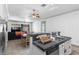 An open-concept kitchen and living space featuring a granite countertop and stainless steel appliances at 1310 Ripplestone Ave, North Las Vegas, NV 89081