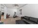 Comfortable living space with a couch, exercise equipment, and views from the window blinds for natural light at 1310 Ripplestone Ave, North Las Vegas, NV 89081