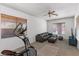 Inviting living room featuring an exercise bike and a cozy couch, perfect for relaxation and fitness at 1310 Ripplestone Ave, North Las Vegas, NV 89081