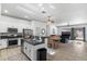 An open concept kitchen, dining, and living area featuring stainless steel appliances and modern decor at 1310 Ripplestone Ave, North Las Vegas, NV 89081