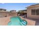 Backyard pool featuring stone perimeter, inset stairs, and views of neighborhood houses at 1310 Ripplestone Ave, North Las Vegas, NV 89081