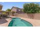 Backyard pool with a covered patio, brick wall, and some landscaping for a relaxing outdoor experience at 1310 Ripplestone Ave, North Las Vegas, NV 89081