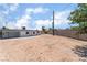 Large backyard with dirt landscaping, a shed, and a block wall at 1313 Purple Sage Ave, Las Vegas, NV 89108
