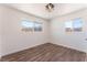 Bright bedroom with wood-look floors, natural light, and a modern light fixture at 1313 Purple Sage Ave, Las Vegas, NV 89108