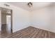 Bedroom featuring wood-look flooring and modern light fixture at 1313 Purple Sage Ave, Las Vegas, NV 89108