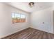 Bedroom featuring wood-look floors, a modern light fixture, and natural light at 1313 Purple Sage Ave, Las Vegas, NV 89108