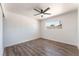 Bright bedroom featuring wood-look floors, a ceiling fan, and a window providing natural light at 1313 Purple Sage Ave, Las Vegas, NV 89108