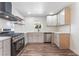 Modern kitchen featuring stainless steel appliances, white cabinetry, and hardwood floors at 1313 Purple Sage Ave, Las Vegas, NV 89108