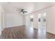 Bright living room with hardwood floors, a ceiling fan, and freshly painted white walls at 1313 Purple Sage Ave, Las Vegas, NV 89108