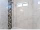 Contemporary shower with decorative accent tile, a showerhead, and a small window at 1313 Purple Sage Ave, Las Vegas, NV 89108