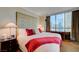 Comfortable bedroom showcasing a plush king bed, a city view, and dark wood furnishings at 135 E Harmon Ave # 2721, Las Vegas, NV 89109