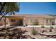 Backyard with covered patio, sliding glass door, gravel landscape, and a Southwestern motif at 1830 Lake Wales St, Henderson, NV 89052