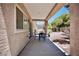 Inviting covered patio with outdoor seating, offering a relaxing view of the landscaped backyard at 1830 Lake Wales St, Henderson, NV 89052