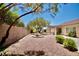 Spacious backyard with gravel landscape, desert landscaping, and a partially covered patio at 1830 Lake Wales St, Henderson, NV 89052