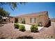 Expansive backyard features desert landscaping, gravel, mature bushes, and a covered patio at 1830 Lake Wales St, Henderson, NV 89052