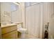 Bright bathroom featuring a large mirror, shower with curtain, and a neutral color palette at 1830 Lake Wales St, Henderson, NV 89052