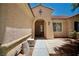 Arched entryway of a single-story home, featuring a tiled path leading to the front door at 1830 Lake Wales St, Henderson, NV 89052