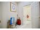 Functional hallway leading to a laundry area, featuring a picture and necessary cleaning supplies at 1830 Lake Wales St, Henderson, NV 89052