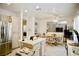 Kitchen area with adjacent desk, stainless steel refrigerator, and kitchen island at 1830 Lake Wales St, Henderson, NV 89052