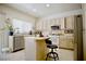 Well-lit kitchen features an island, stainless steel appliances, and tile flooring at 1830 Lake Wales St, Henderson, NV 89052