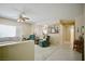 Bright and airy living room featuring neutral tones, comfortable seating, and a ceiling fan at 1830 Lake Wales St, Henderson, NV 89052